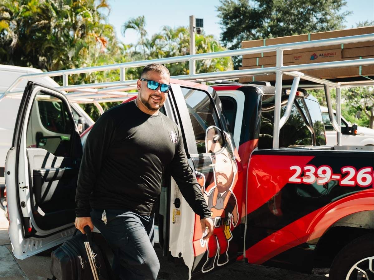 Prime Garage Door technician servicing a residential garage door in Bonita Springs, Florida