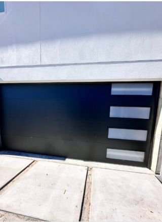 Garage Door Repair Naples FL | Prime Garage Door Modern black garage door with horizontal frosted windows installed on a home in Naples, FL